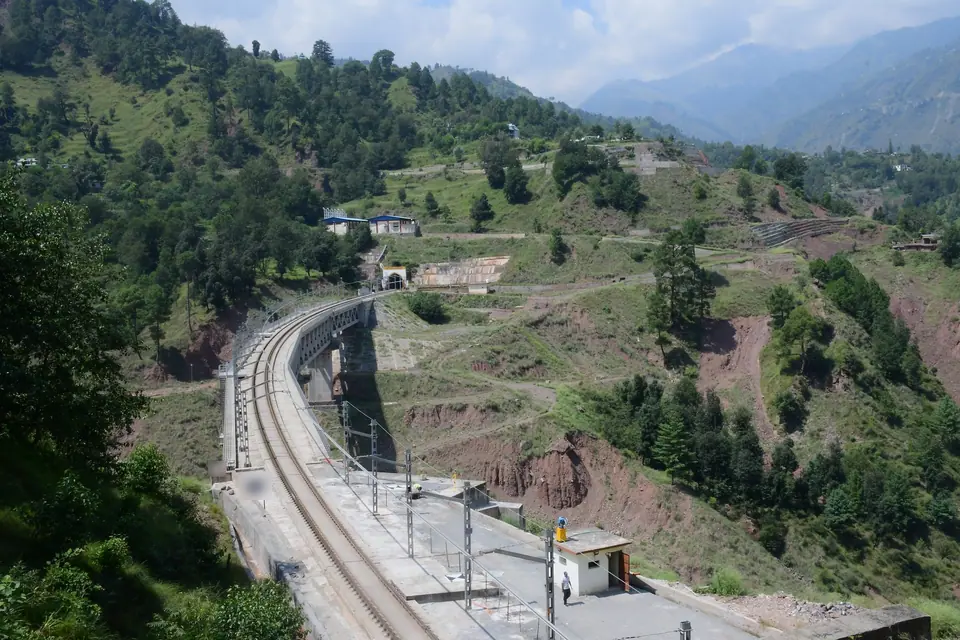 The USBRL at Sangaldan from the hillside: slab track on a bridge approach, with a tunnel portal beyond