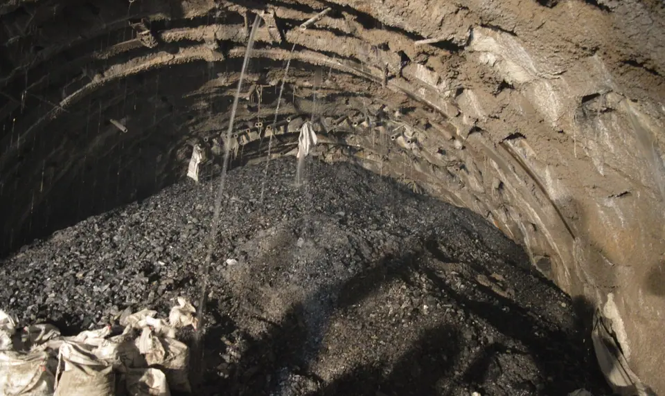 Water pouring from the crown of USBRL tunnel T-5 onto the muck pile, before treatment