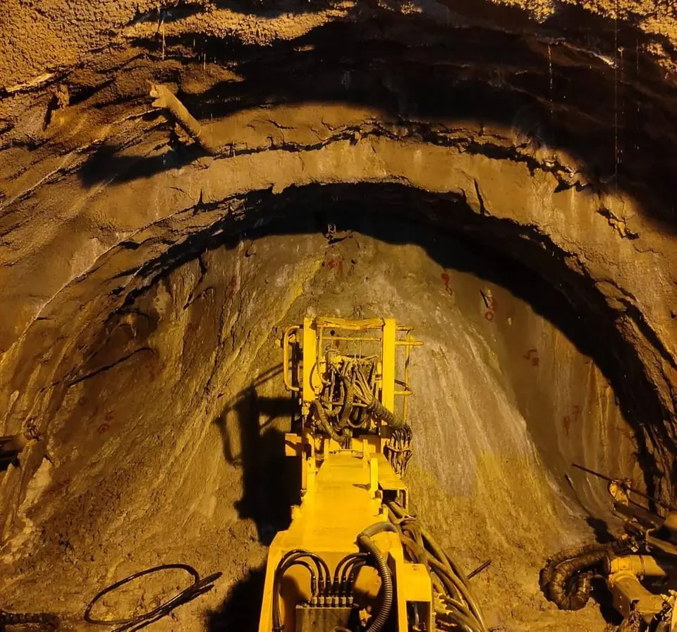 Drill rig working at a tunnel face under site lights