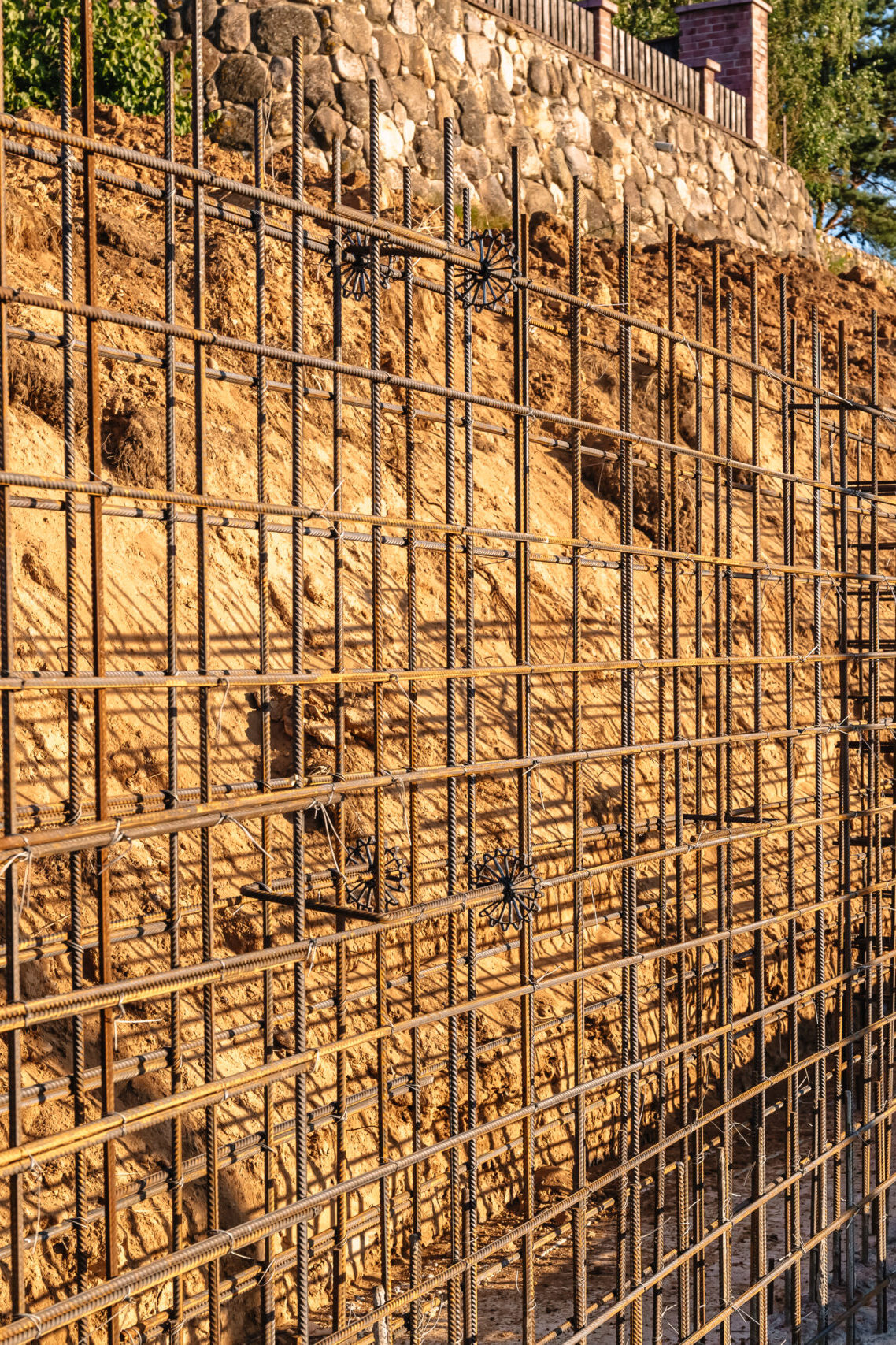 The construction of a retaining wall or counterfort, formwork, reinforced, preparation to pour concrete, construction site. Improvement of the territory. Preventive measures against landslide.