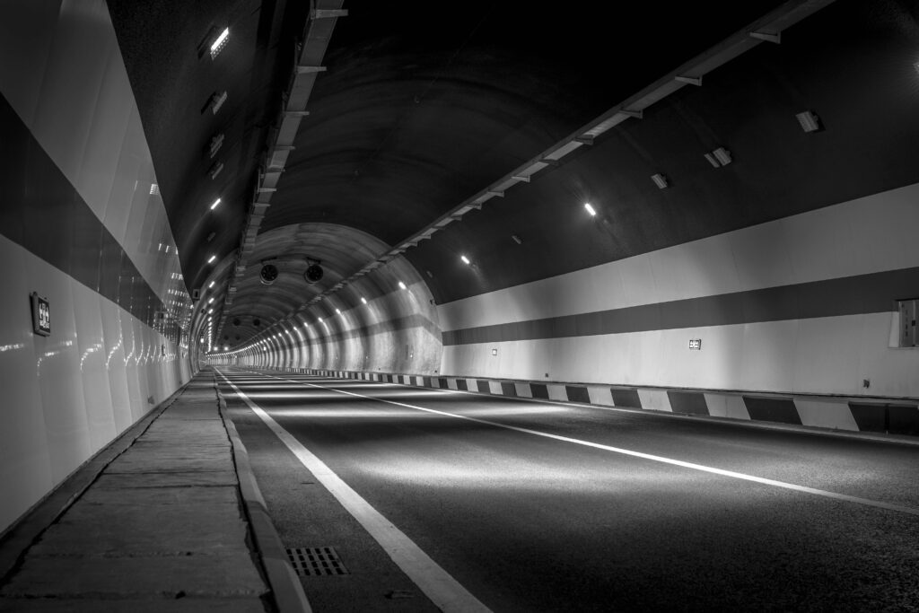 Grayscale photography of empty tunnel